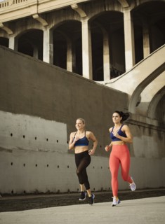 USA, California, Los Angeles, Two sporty women jogging in urban setting