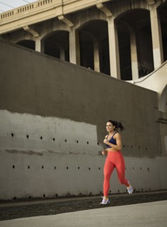 USA, California, Los Angeles, Sporty woman jogging in urban setting