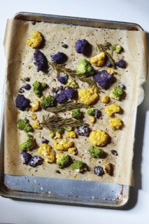Roasted cauliflower with rosemary and olive oil on parchment paper
