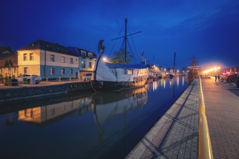 Poland, Pomerania, Leba, Historic ship moored in harbour at night