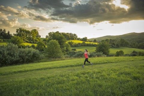 USA, Woman running in field