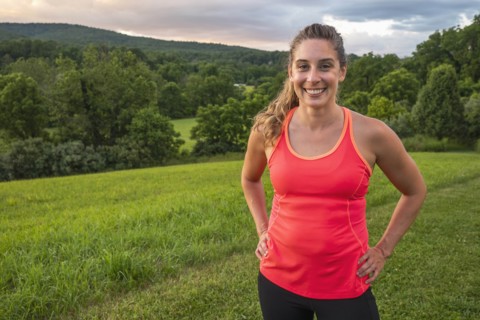 USA, Woman in running outfit standing in field