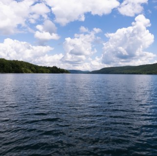 USA, New York, Cooperstown, Otsego Lake, Clouds over lake surrounded by hills