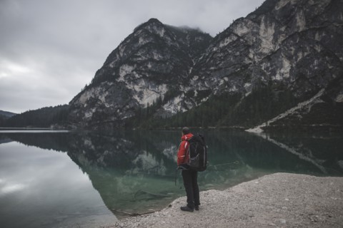Italy, Pragser Wildsee, Dolomites, South Tyrol, Man looking at view standing near mountain lake