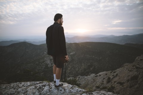 Italy, Liguria, La Spezia, Man looking at mountain range from mountain top