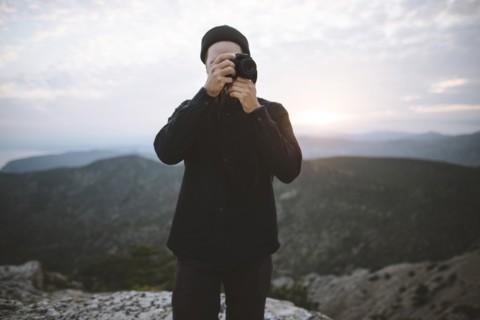 Italy, Liguria, La Spezia, Man using camera in mountains