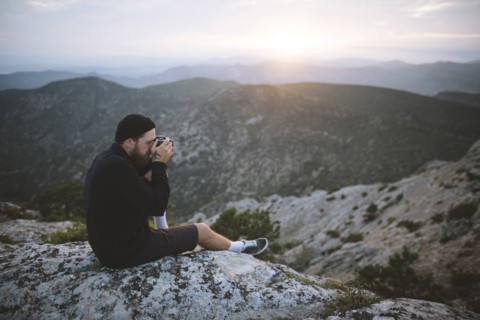 Italy, Liguria, La Spezia, Man photographing mountain range from mountain top