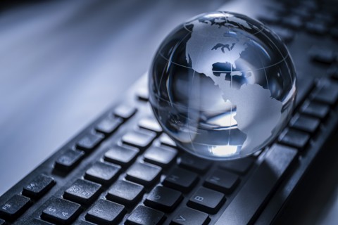 Glass globe on computer keyboard