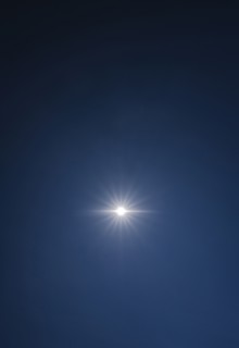 Sun shining on clear blue sky