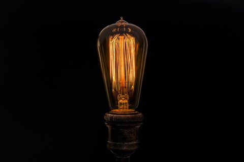 Edison light bulb on black background