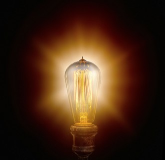 Edison light bulb on black background