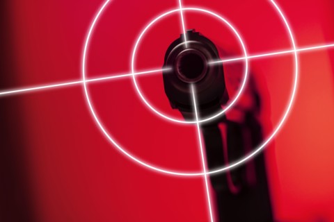 Shooting target on red background with gun