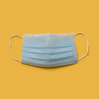 Flu mask on orange background