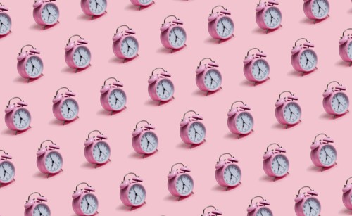 Alarm clocks on pink background