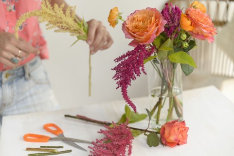 Woman making floral arrangement