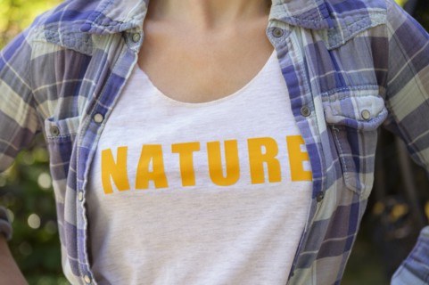 Midsection of girl (6-7) wearing nature t-shirt