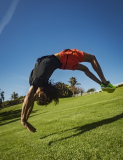 Man flipping over grass