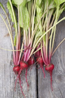 Fresh radishes with leaves on wooden table