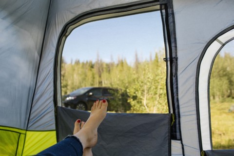 USA, Utah, Uinta National Park, Woman's legs in tent on camping
