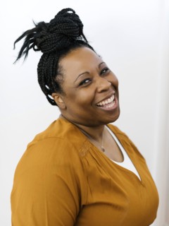 Portrait of smiling woman with black braided hair