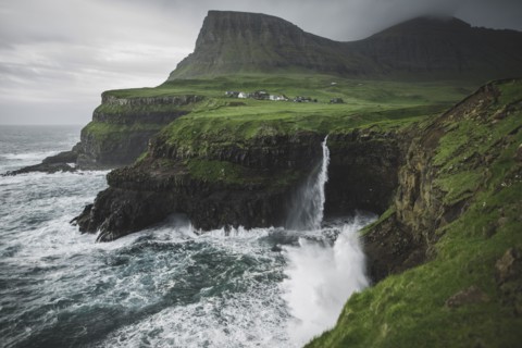 Denmark, Faroe Islands, Gasadalur village, Mulafossur Waterfall, Mulafossur Waterfall falling from cliff into ocean