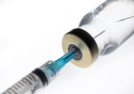 Studio shot of Covid-19 vaccine and syringe
