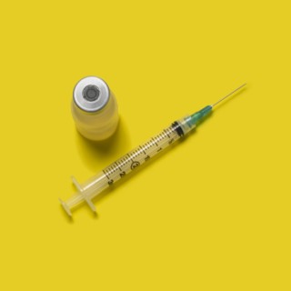 Studio shot of laboratory vial and syringe