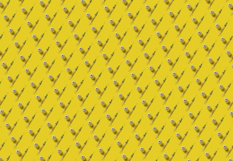 Rows of laboratory vials and syringes on yellow background