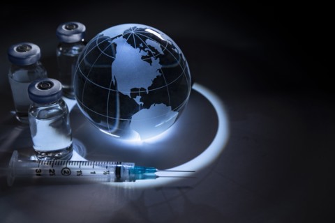 Glass globe with vials and syringe