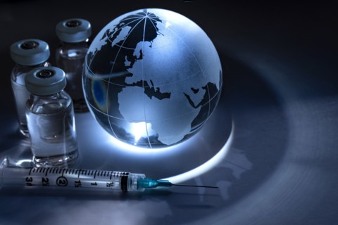 Glass globe with vials and syringe