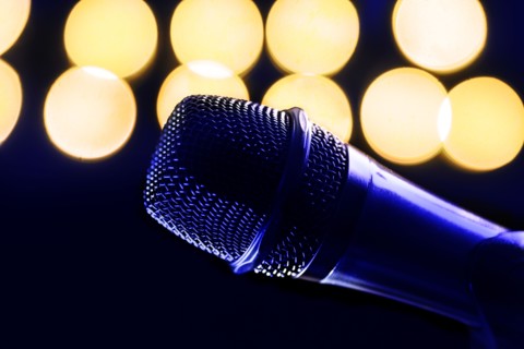 Close-up of microphone and stage lights