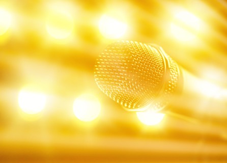 Close-up of microphone and stage lights