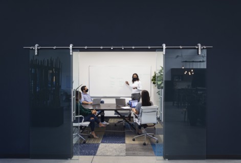Businesspeople in face masks having meeting in office