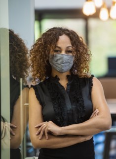 Portrait of woman in face mask standing in office