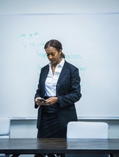 Businesswoman text messaging in office