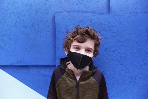 Boy (8-9) wearing protective face mask