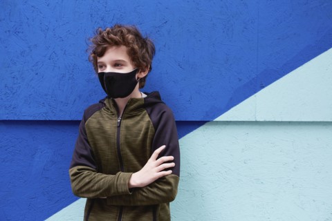 Boy (8-9) wearing protective face mask
