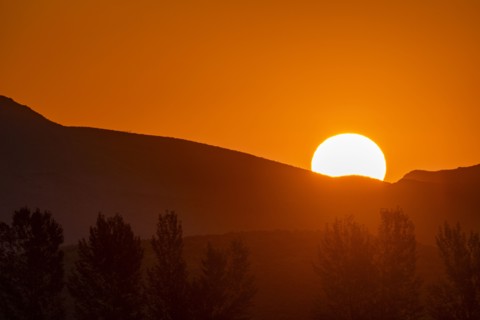 Sun rising behind mountain
