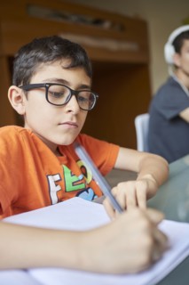 Two boys learning at desk at home during Covid-19 lockdown