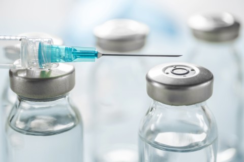 Close-up of Covid-19 vaccine and syringe
