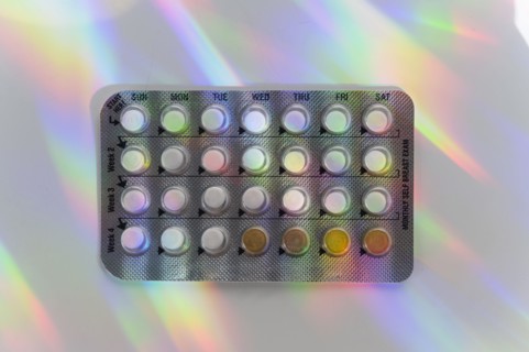 Birth control pills with colorful reflections