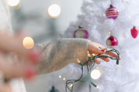 Woman preparing to decorate Christmas tree