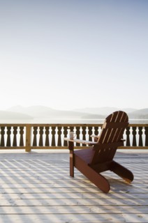 Adirondack chair on deck by lake