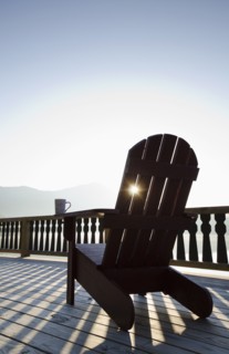 Adirondack chair on deck by lake