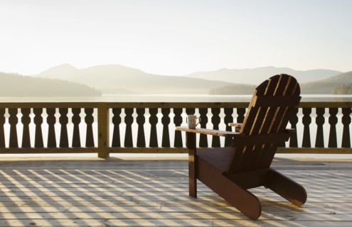 Adirondack chair on deck by lake