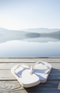 Pair of white sandals on dock