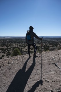 Female hiker looking at Galisteo Basin Preserve
