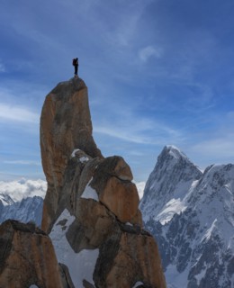 Chamonix, Climber standing on top of Aiguille du Midi in Mont Blanc Massif