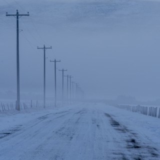 Empty frozen rural road in winter