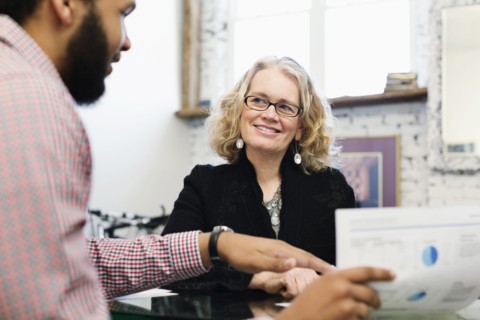 Businesswoman talking to young businessman
